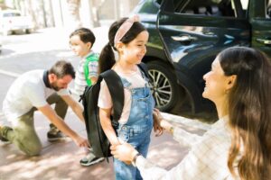 family in front of car